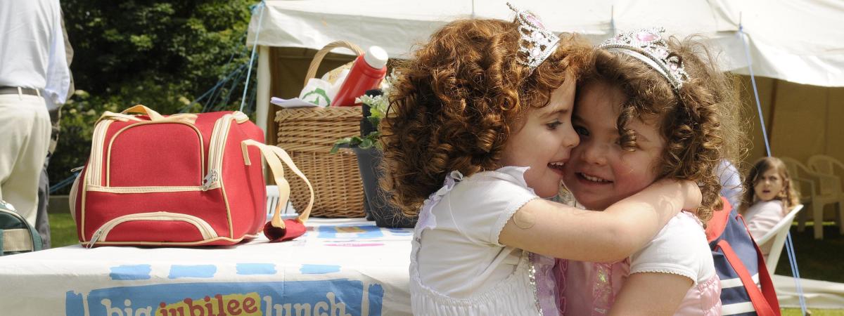 Jessica Kee enjoys her sister Sophie's company at The Big Jubilee Lunch during the Diamond Jubilee Celebration in Grey Point Fort, Helens Bay.