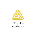 The Photo Academy NI logo - yellow and black triangle with the words photo academy written underneath